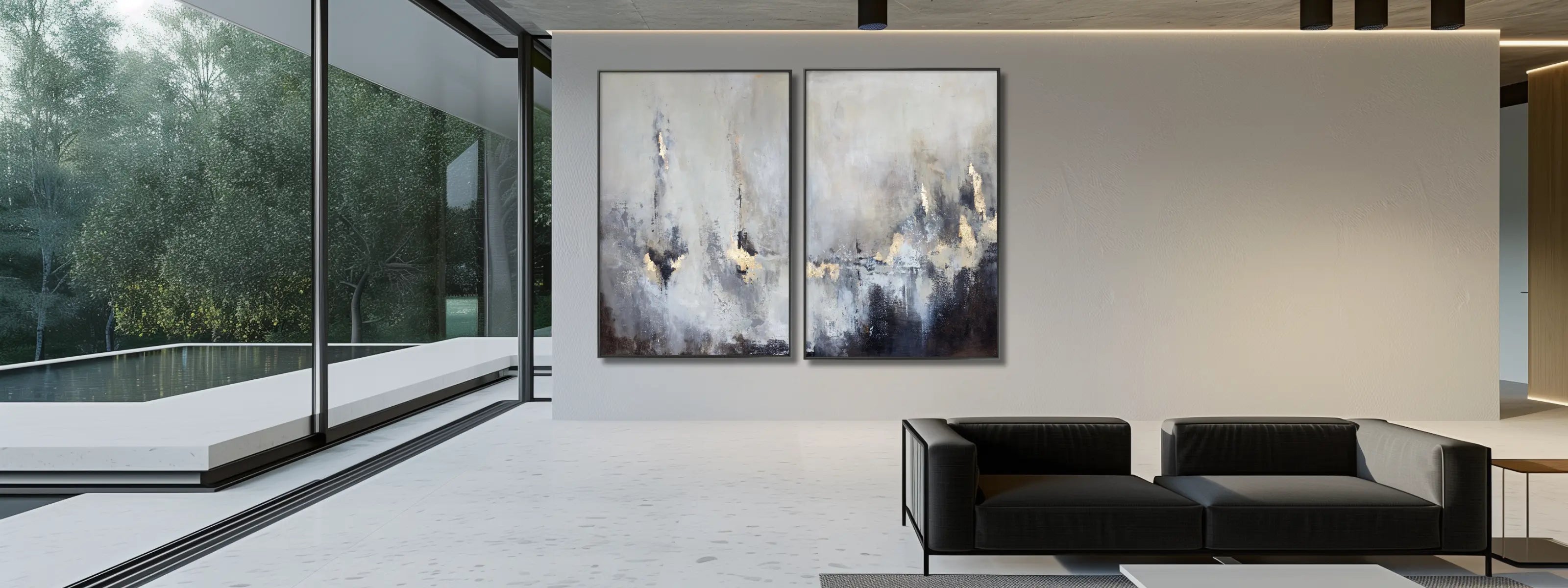 Minimalist living room with a black sofa and a set of abstract artwork on a gallery wall. 