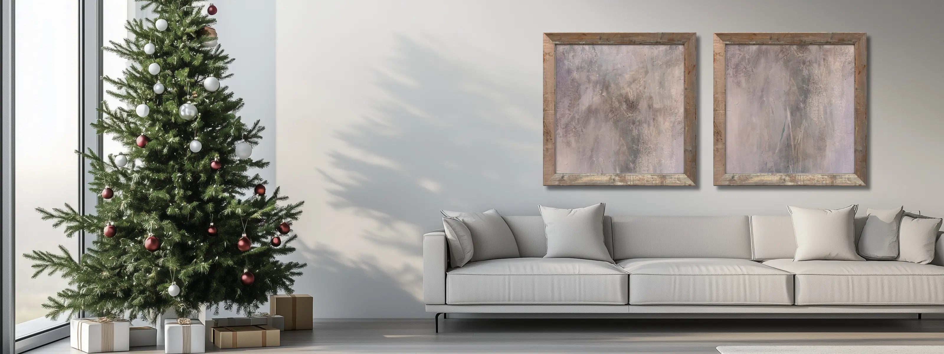 Minimalist living room with a white sofa and a set of abstract artwork on a gallery wall next to a minimalist Christmas tree. 