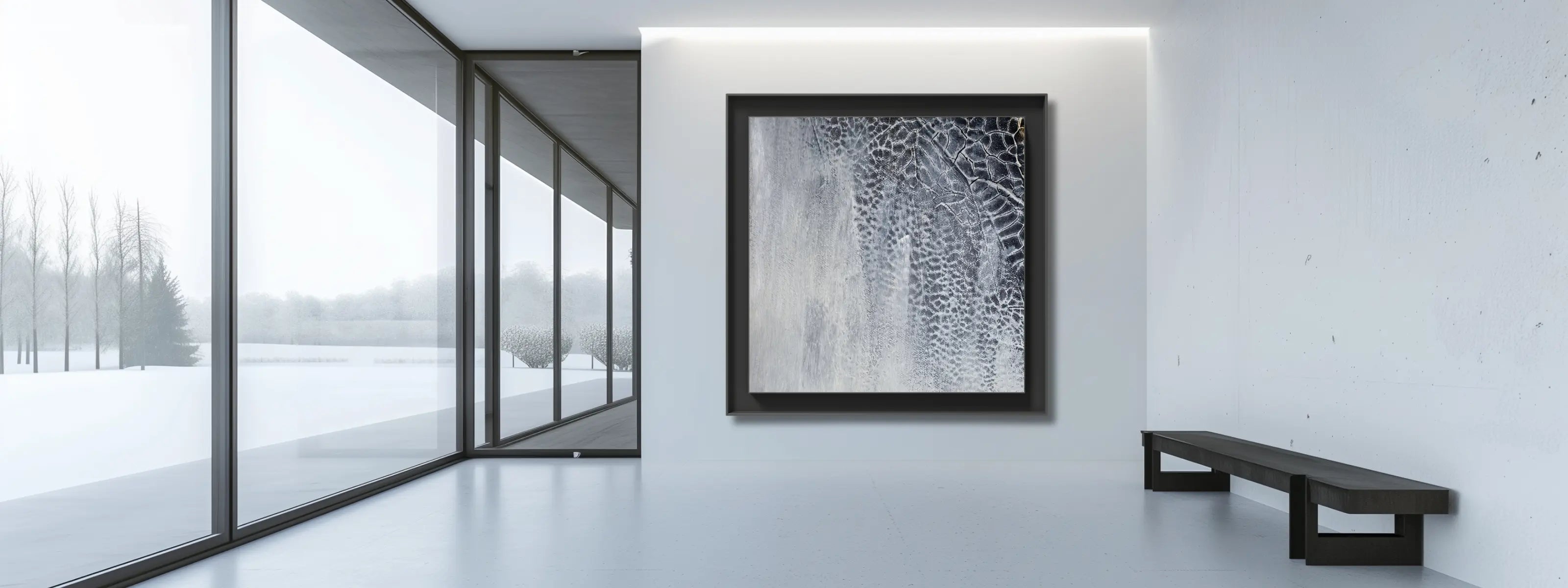 Contemporary living room with minimalist abstract art in black and white on a white wall. 