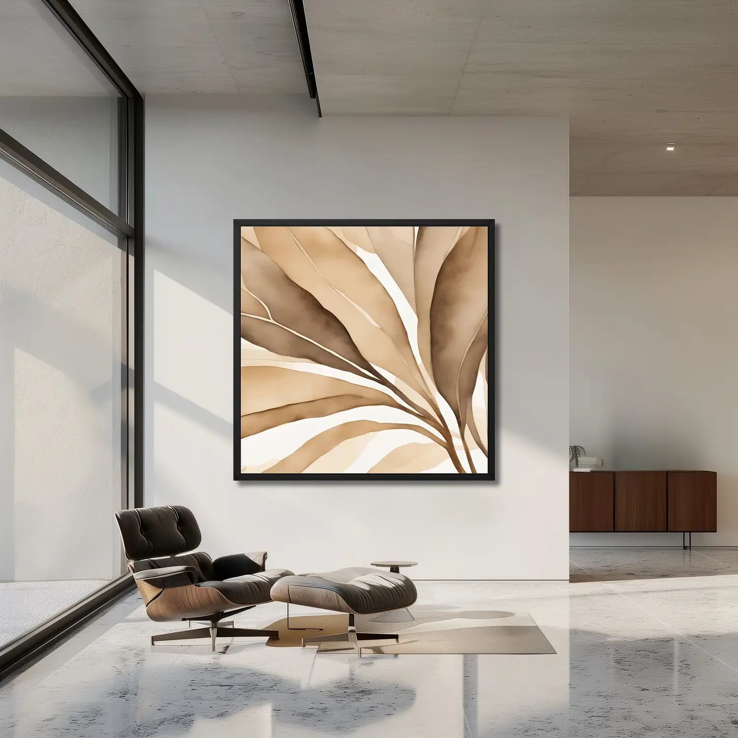 Modern living room with framed abstract wall art in beige and a designer black armchair. 